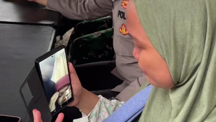 1764522401773-seorang-korban-banjir-yang-menangis-saat-menghubungi-keluarganya-foto-dok-polres-tapteng-1764516906430_169